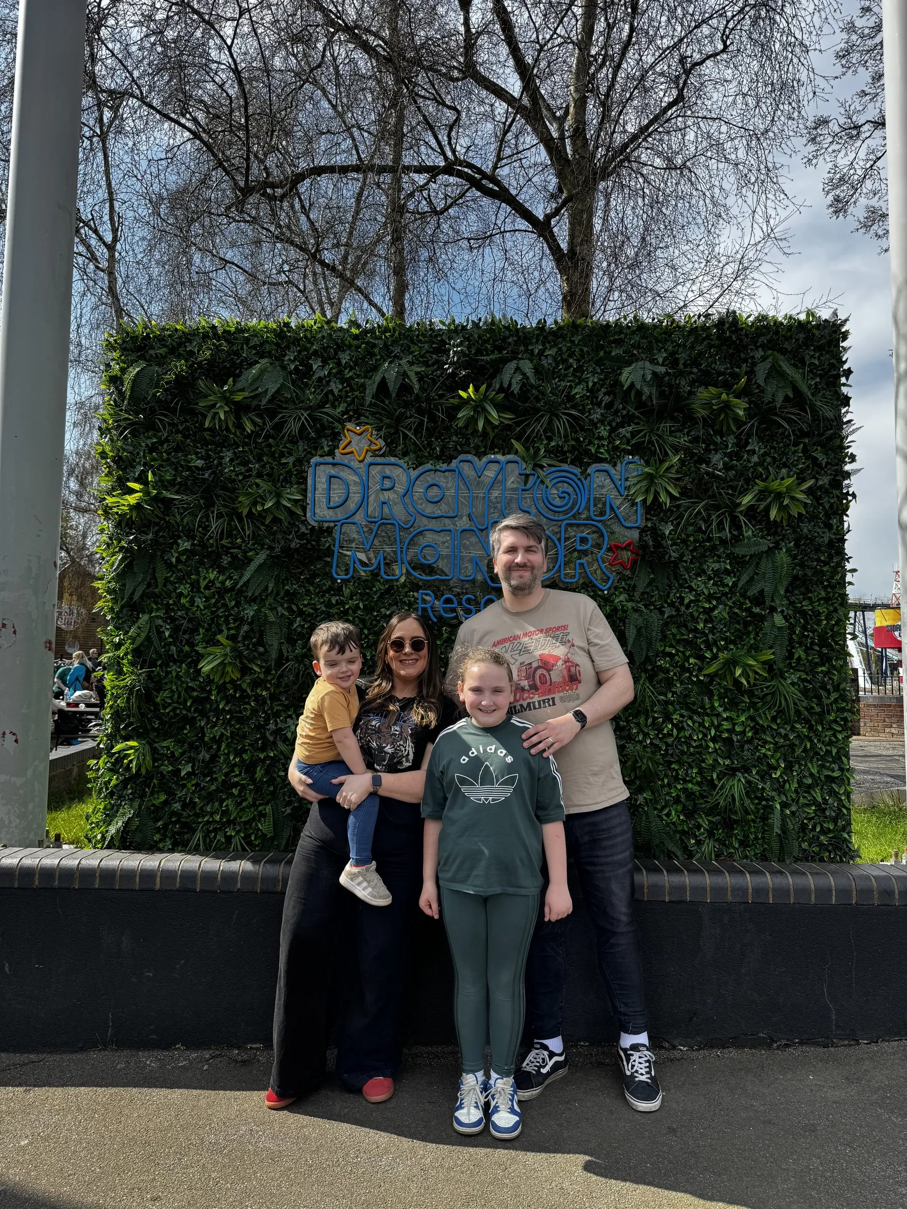 The whole family posing together at a theme park